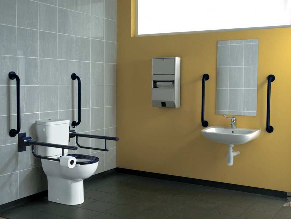 Armitage Shanks Contour 21 raised height white close coupled toilet pan in accessible bathroom with grab rails and sink