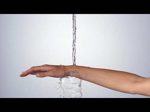 Water falling onto forearm illustrating flow control of Hansgrohe Metropol floor standing bath mixer in chrome finish