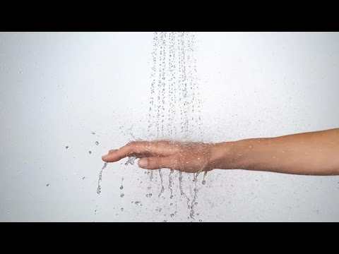 Hansgrohe Croma Select S hand shower in white and chrome with water spray and hand demonstration