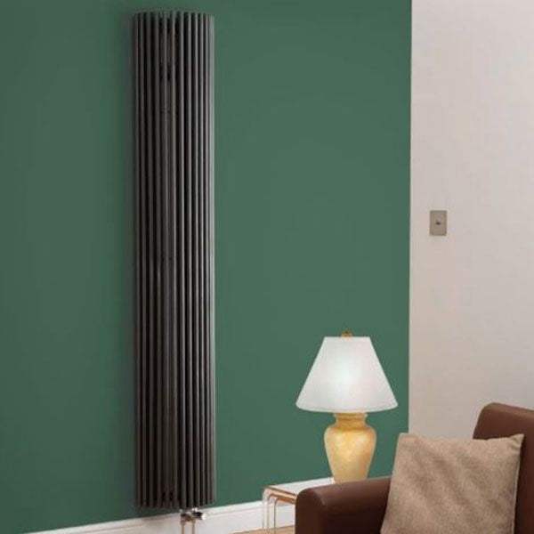 Kartell K-Rad Cincinnati anthracite vertical designer radiator installed on green wall in modern living room
