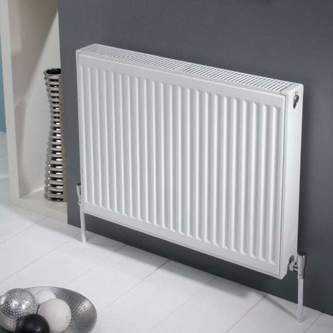 Kartell K-Rad Max Rad 900mm H x 400mm W white single convector compact radiator mounted on grey wall in modern bathroom