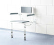 Impey Deluxe padded fold down shower seat with adjustable height and durable powder coated frame mounted on tiled bathroom wall