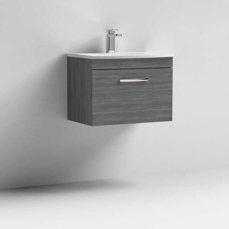 Nuie Athena 1-Drawer Wall Hung Vanity Unit with Brown Grey Avola finish and ceramic basin mounted on white wall