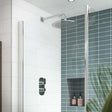 Nuie Binsey dual handle thermostatic concealed shower valve in chrome installed in modern bathroom with tiled walls and rain showerhead