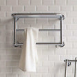 Chrome heated towel rail 400mm high x 640mm wide with warm towel hanging on white tiled bathroom wall.