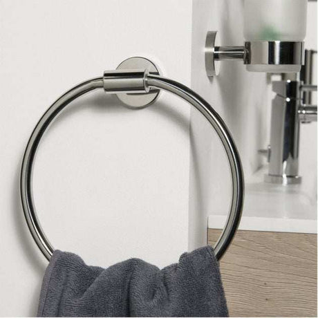Coram Boston Chrome Towel Ring mounted on bathroom wall with gray towel hanging, sleek chrome finish, modern design.