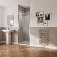 Modern bathroom with Coram 5mm plain glass pivot shower door in chrome finish and clear glass installed in alcove