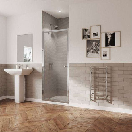 Modern bathroom with Coram 5mm plain glass pivot shower door in chrome finish and clear glass installed in alcove