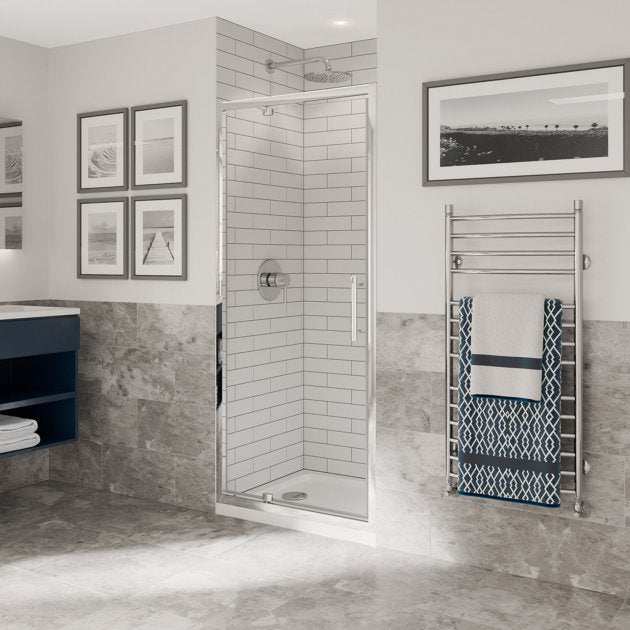 Coram 6mm Plain Glass Optima 6 Chrome 700mm wide pivot shower door with clear glass and chrome frame in modern bathroom setting