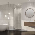 Coram 8mm Plain Glass chrome framed bi-fold shower door with clear glass in modern bathroom setting