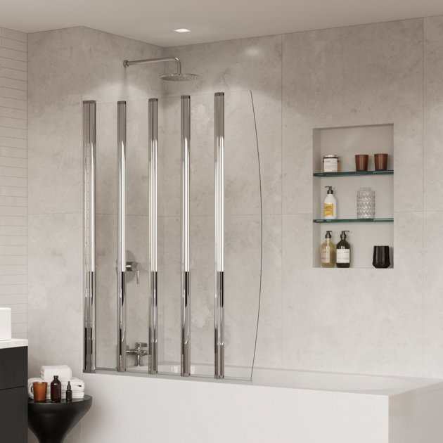 Coram 4mm glass five folding clear bath screen installed on white bathtub with tiled bathroom wall and recessed shelves