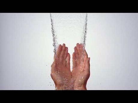 Hands catching clear water stream from chrome Hansgrohe Metropol Bath Spout with 185mm projection