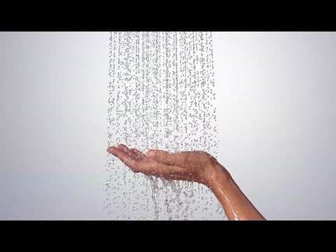 Hansgrohe Raindance Select E hand shower in matt white with 120mm head and three spray modes showing water flow on a hand