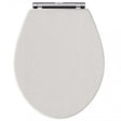 Toilet seat with traditional chrome hinges in timeless sand shade, featuring soft close mechanism for quiet closing.
