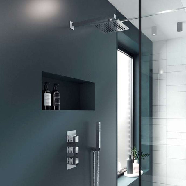 Modern bathroom shower showcasing Nuie Triple Handle Series L Concealed Shower Valve in chrome with triple handle controls beneath a ceiling-mounted rain showerhead.