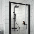 Nuie Round Mixer Shower thermostatic bar with fixed rainfall showerhead and handheld spray in matt black finish installed in modern white tiled bathroom shower enclosure.