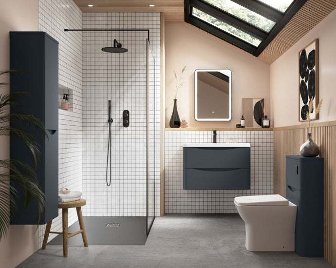Modern bathroom interior featuring Nuie Arvan Diverter Dual Handle Thermostatic Concealed Shower Valve in matt black with glass shower enclosure and navy blue cabinets.