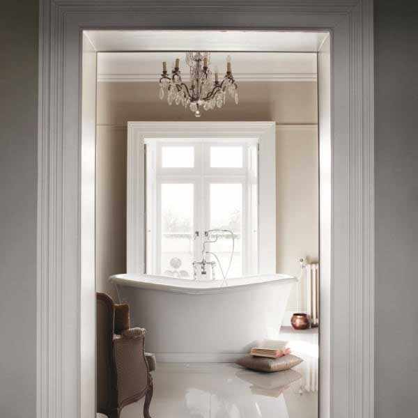 White Burlington Admiral Roll Top freestanding bath in elegant bathroom setting with chandelier and natural light