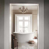 White Burlington Admiral Roll Top freestanding bath in elegant bathroom setting with chandelier and natural light