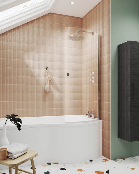 Nuie Curved Bath Screen in Polished Chrome installed on a modern bathtub with beige tiled wall and showerhead