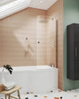 Nuie Curved Bath Screen in Polished Chrome installed on a modern bathtub with beige tiled wall and showerhead