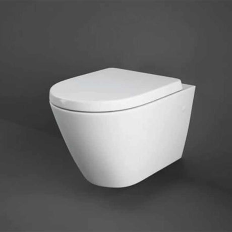 White RAK Resort wall hung toilet pan with sleek modern design and closed seat cover against dark background