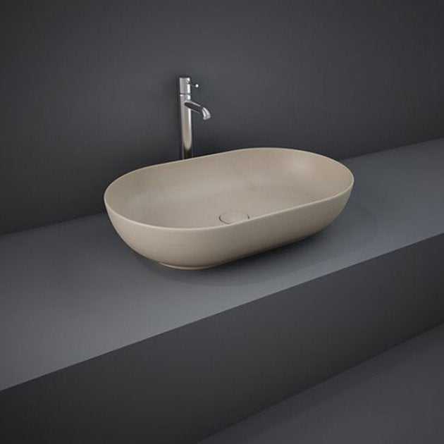 RAK Feeling Modern oval countertop wash basin in matt cappuccino finish on dark grey countertop