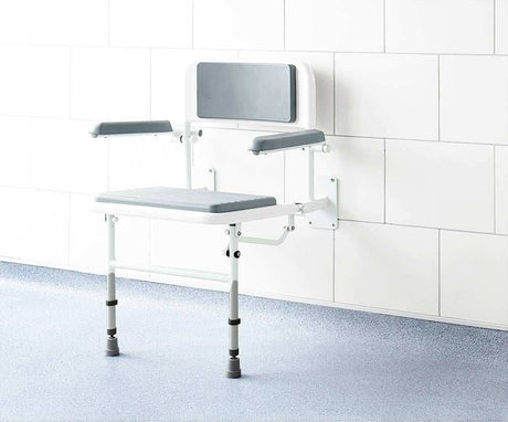 Impey Deluxe padded fold down shower seat with adjustable height and durable powder coated frame mounted on tiled bathroom wall