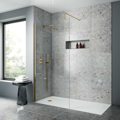 Modern bathroom featuring Nuie Arvan Dual Handle Thermostatic Concealed Shower Valve in brushed brass with glass shower enclosure and gray stone tiles